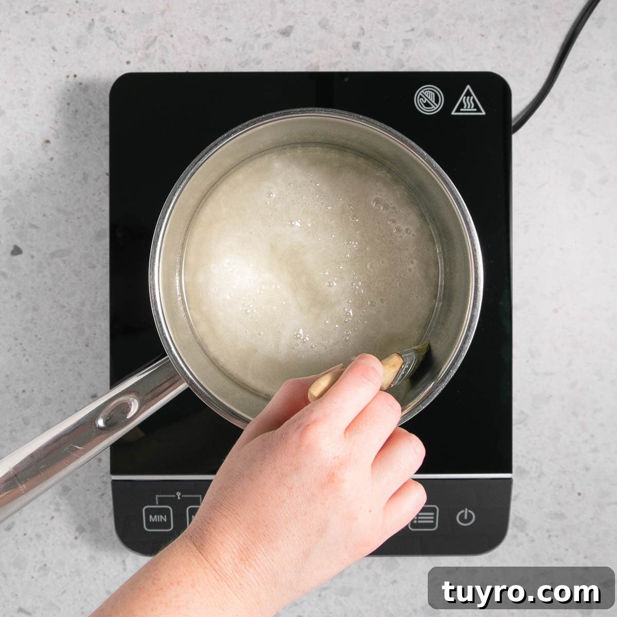 Decadent Chocolate Caramel Sauce Recipe for Desserts 4 The sugar, water and corn syrup in a stainless steel pan on an induction hot plate.