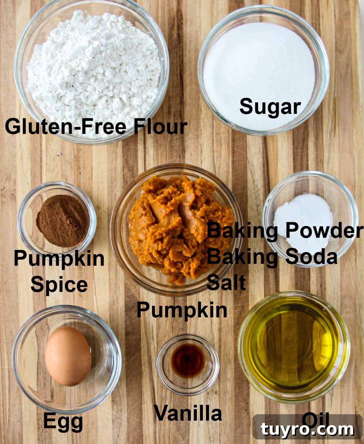 Gluten Free Pumpkin Bread Recipe 4 The ingredients for this recipe in glass bowls on a wooden board.