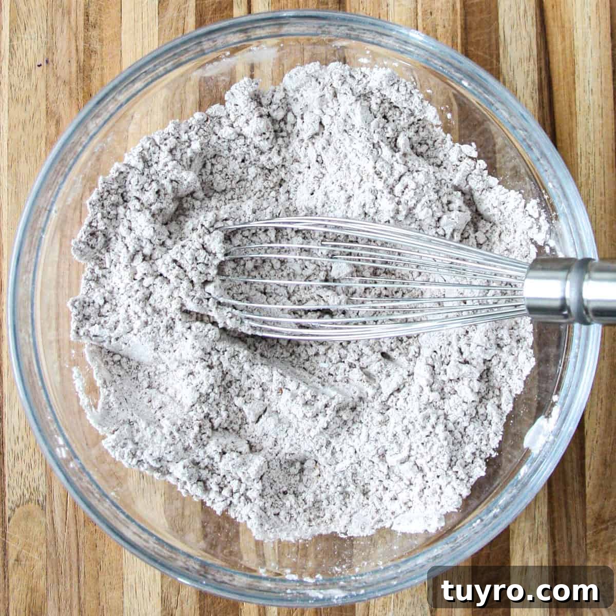 Gluten Free Pumpkin Bread Recipe 5 The flour, spices, baking soda, salt and baking powder in a glass bowl with a whisk.