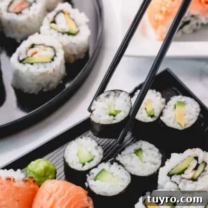 Cucumber rolls with one piece picked up with chopsticks.