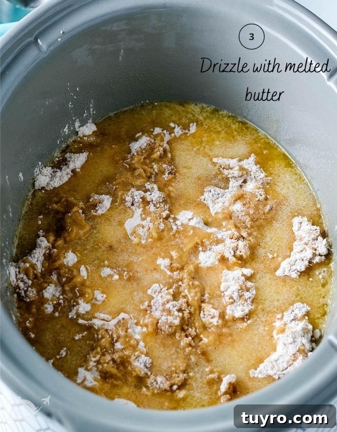 Slow Cooker Apple Dump Cake Recipe for Fall Desserts 6 apple dump cake in a crockpot before baking after butter has been drizzled