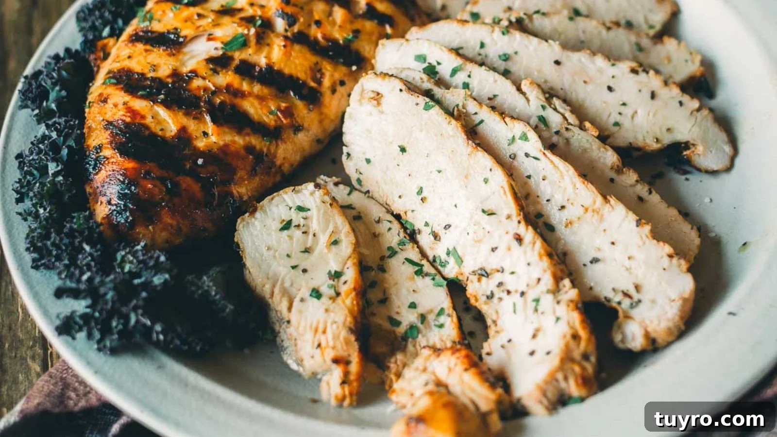 Grilled turkey tenderloin with lemon herbs sliced thin and arranged on a platter.