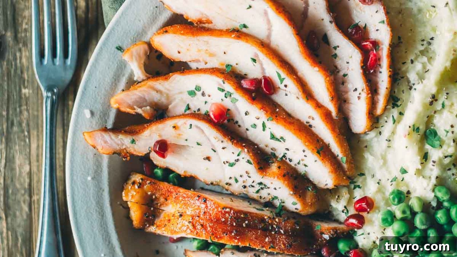 Smoked turkey tenderloin sliced to reveal juicy interior with herbal seasoning.