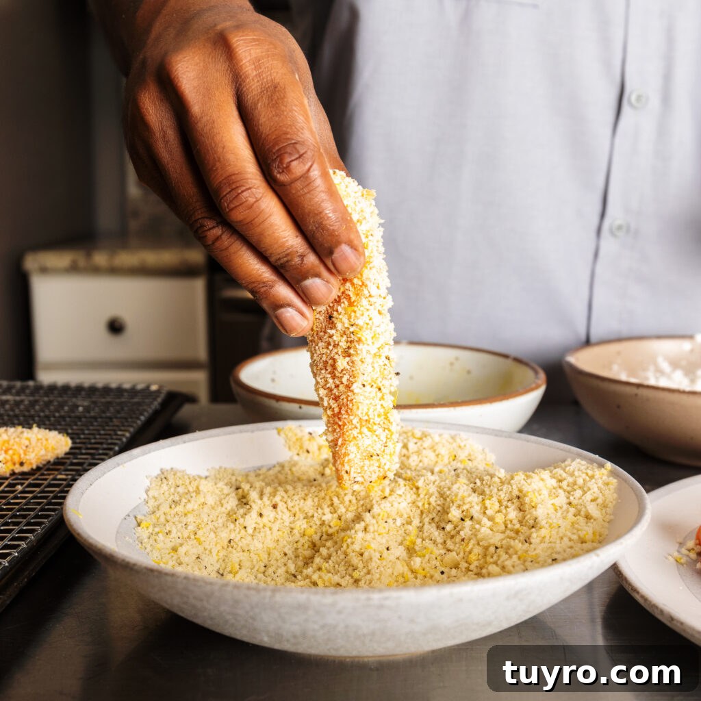 dredging salmon strips in panko mixture
