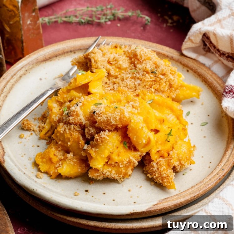 Sweet potato mac and cheese on plate with fork.