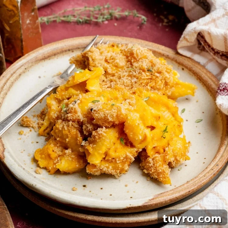 Sweet potato mac and cheese on plate with fork.