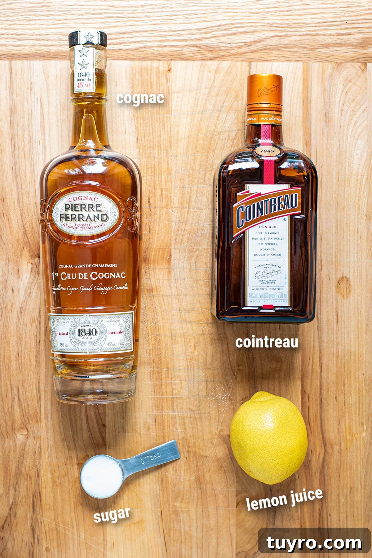 Classic Sidecar Cocktail Recipe: How to Mix the Perfect Brandy Sour 3 Sidecar cocktail ingredients on a butcher block.