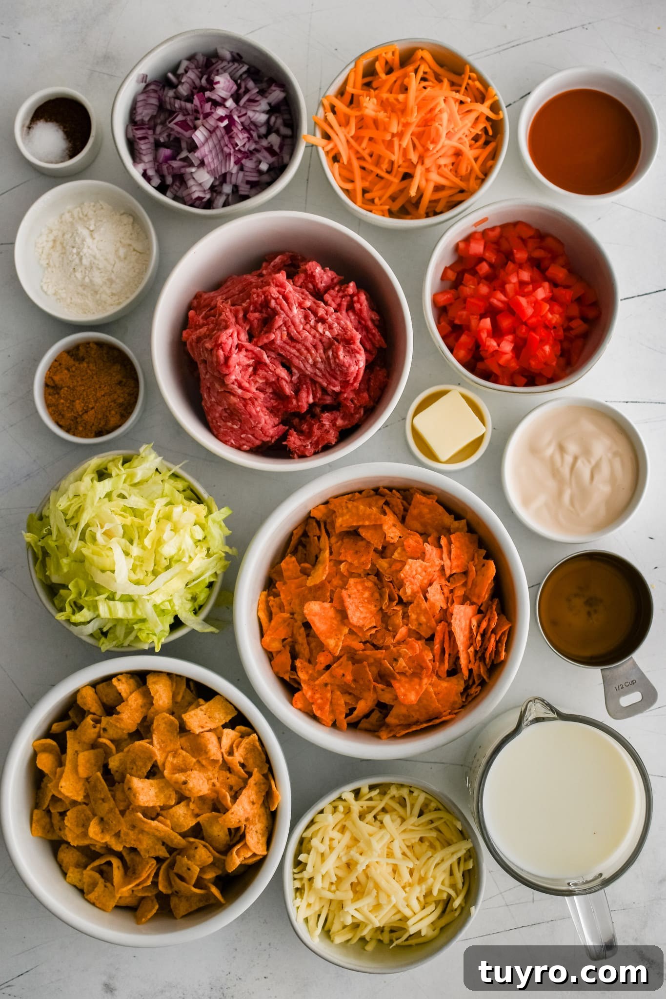 All of the ingredients needed to make walking taco casserole recipe in individual measuring cups and ramekins.