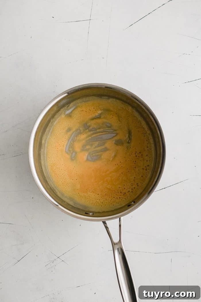 Small stainless steel saucepan filled with a golden roux.