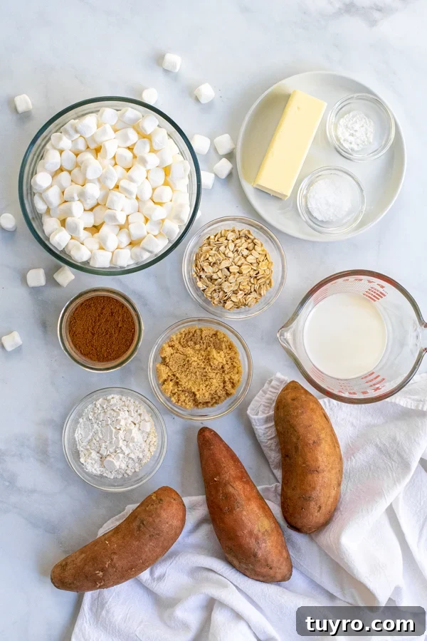 Ingredients for Sweet Potato Casserole with Marshmallows and Oat Streusel laid out on a table with a kitchen towel.