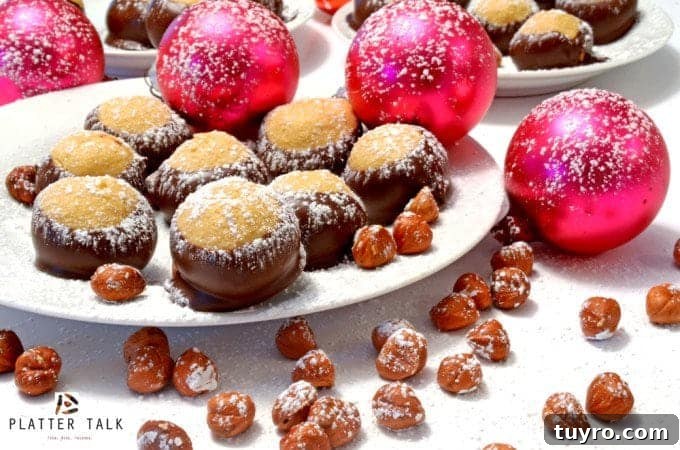 Nutella Buckeyes: Creamy Chocolate Hazelnut Truffle Recipe 4 Plate of holiday treats with ornaments and hazelnuts, dusted with powedered sugar.