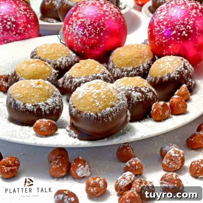 Nutella Buckeyes: Creamy Chocolate Hazelnut Truffle Recipe 7 Festive plate of buckeye candies with hazelnuts and ornaments dusted with powdered sugar.