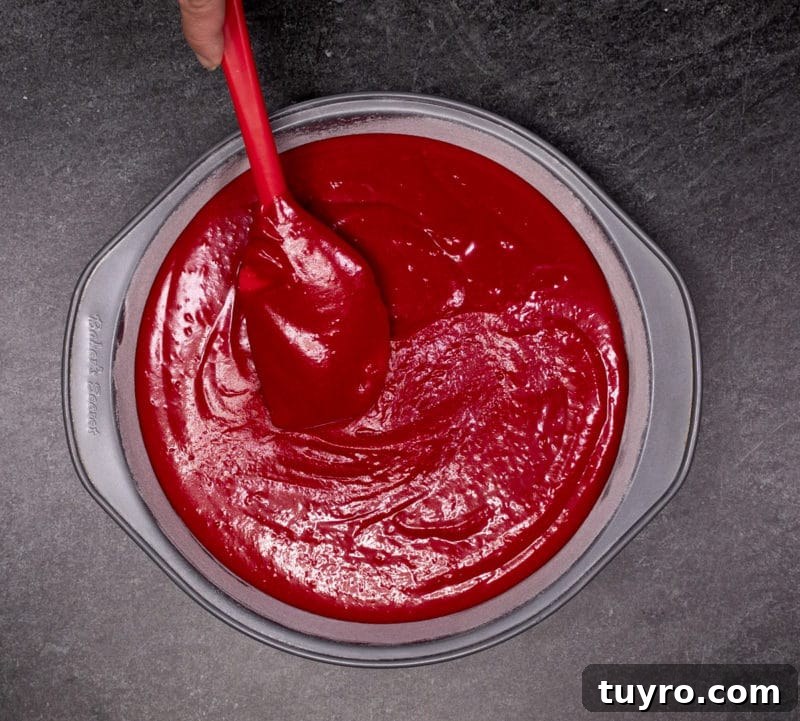 Classic Red Velvet Cake with Cream Cheese Frosting 10 cake batter in a round cake pan.