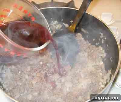Spaghetti with Classic Greek Meat Sauce (Makaronia me Kima) 5 Adding wine to the greek recipe makaronia me kima, greek spaghetti with meat sauce