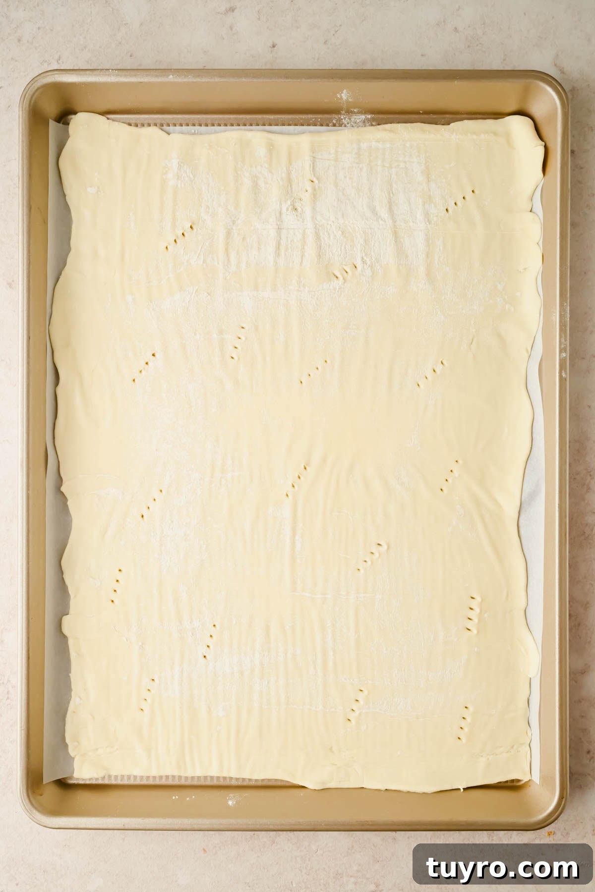 Rustic Peach and Berry Galette Recipe 5 puff pastry rolled out onto parchment paper on baking sheet.