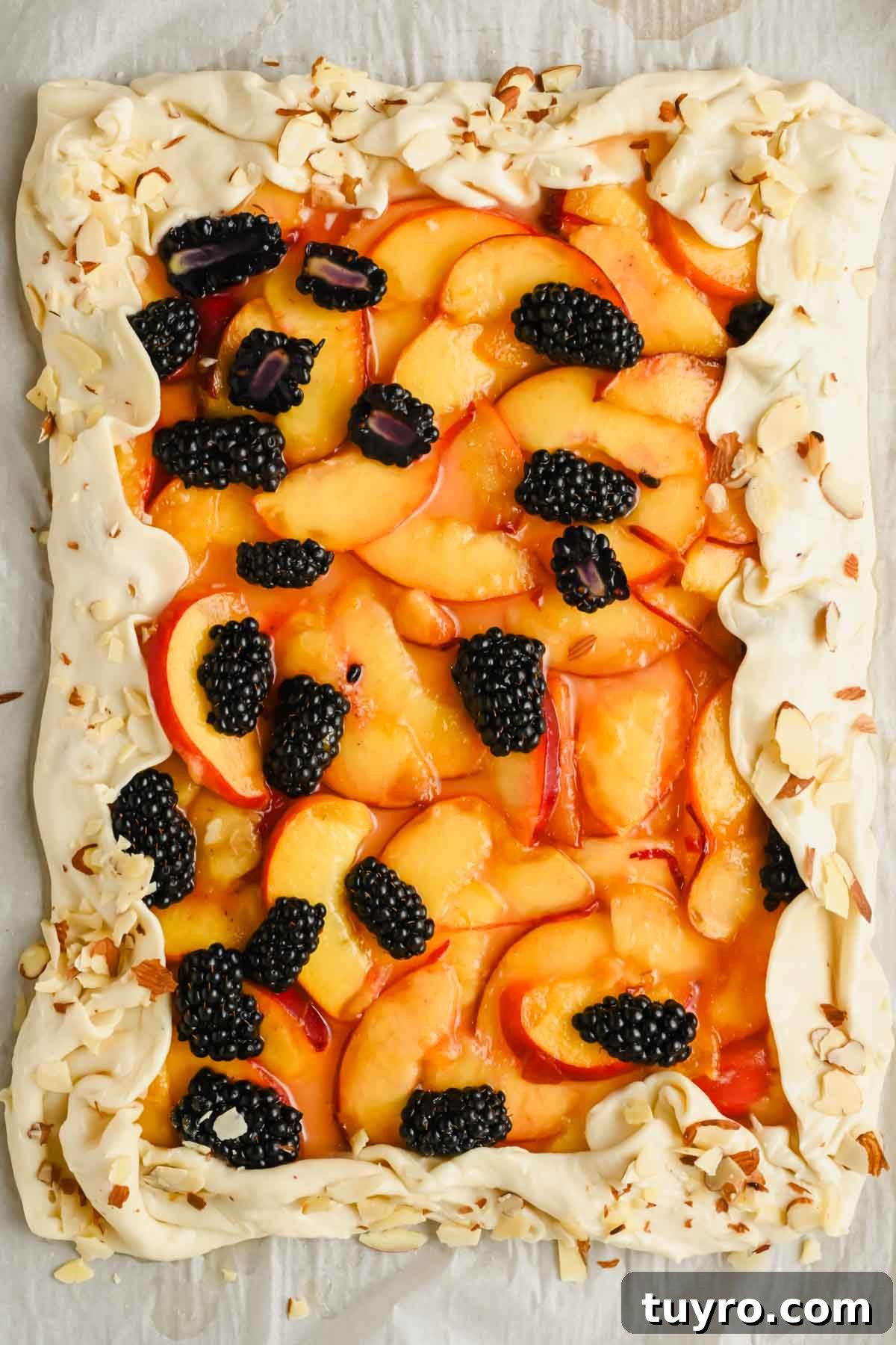 Rustic Peach and Berry Galette Recipe 7 summer peach galette assembled on a baking sheet before baking.