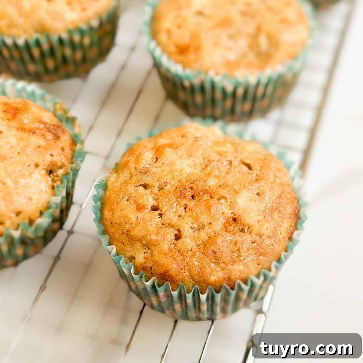 Sourdough banana muffins on a wire cooling rack.