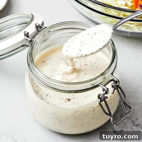 14 Fresh Salad Dressings and Vinaigrettes You’ll Love 12 A container with coleslaw dressing and a spoon.